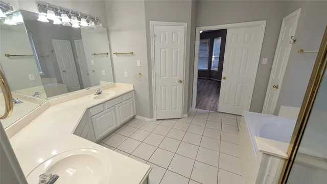 a en suite bathroom with a double vanity sink a toilet and a shower