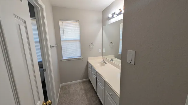 a bathroom with a double vanity sink and mirror
