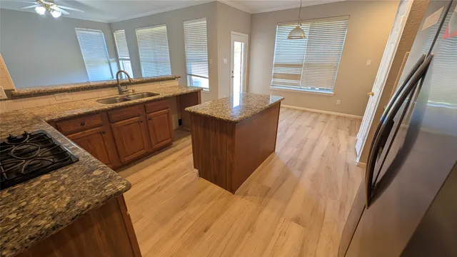 a view of a kitchen counter space and windows