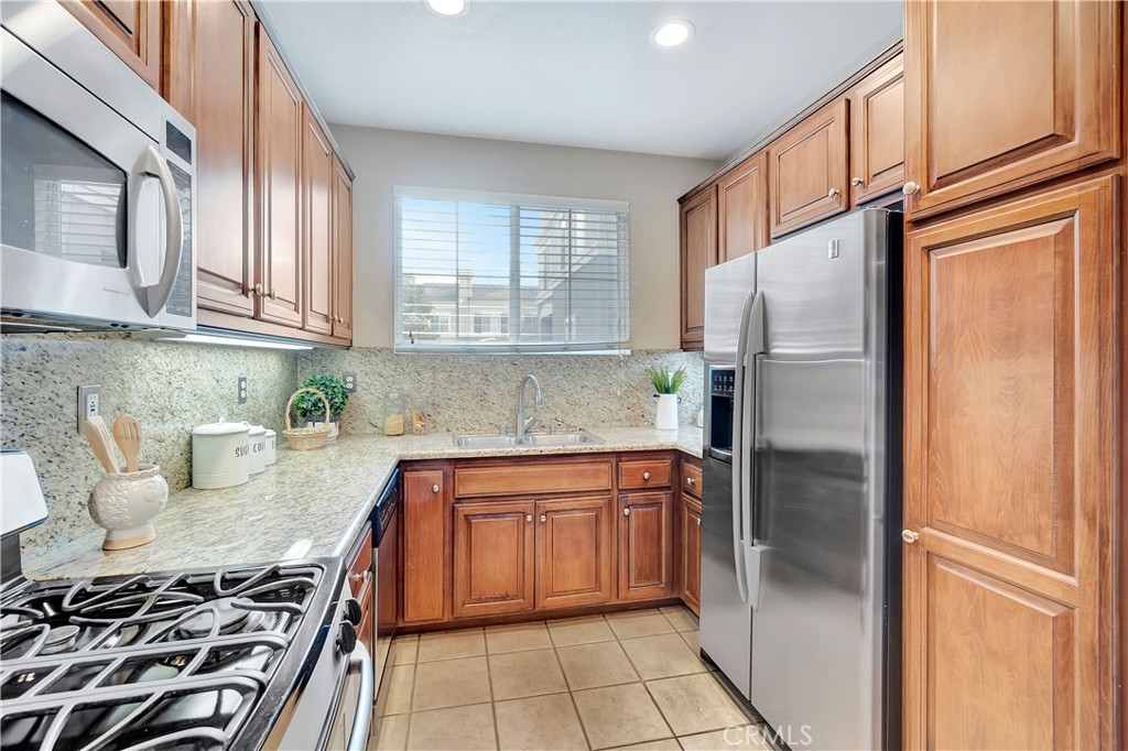 3405 South Main Street, Unit D Santa Ana, CA 92707 - Photo 12 of 30 a kitchen with stainless steel appliances granite countertop a refrigerator sink and stove