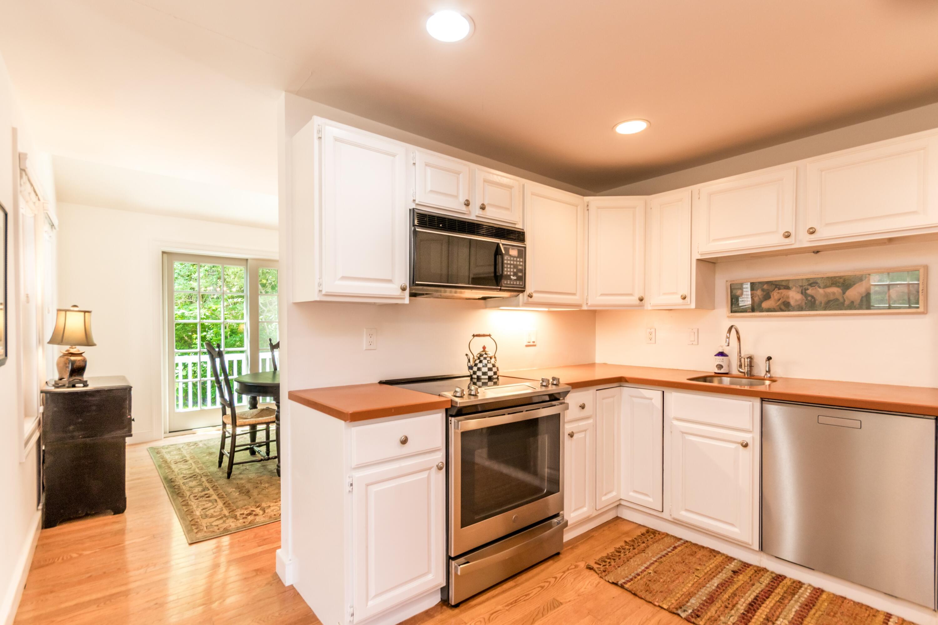 15 Hampton Court, Unit 15 Mashpee, MA 02649 - Photo 11 of 40 a kitchen with a stove a sink and a microwave
