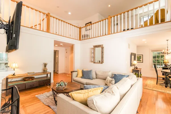 a living room with fireplace furniture and a flat screen tv