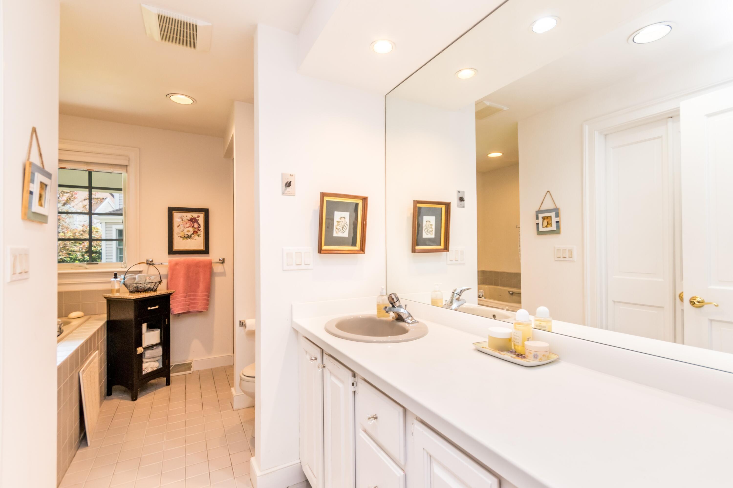 15 Hampton Court, Unit 15 Mashpee, MA 02649 - Photo 21 of 40 a bathroom with a sink double vanity and a mirror