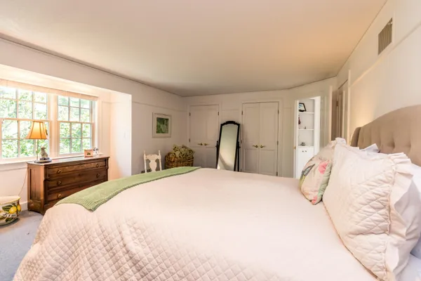 a bedroom with a bed and a tv