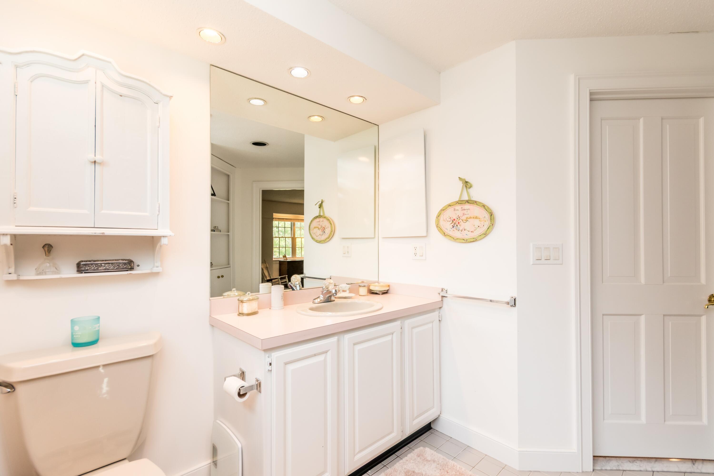 15 Hampton Court, Unit 15 Mashpee, MA 02649 - Photo 27 of 40 a bathroom with a sink a toilet a mirror and vanity