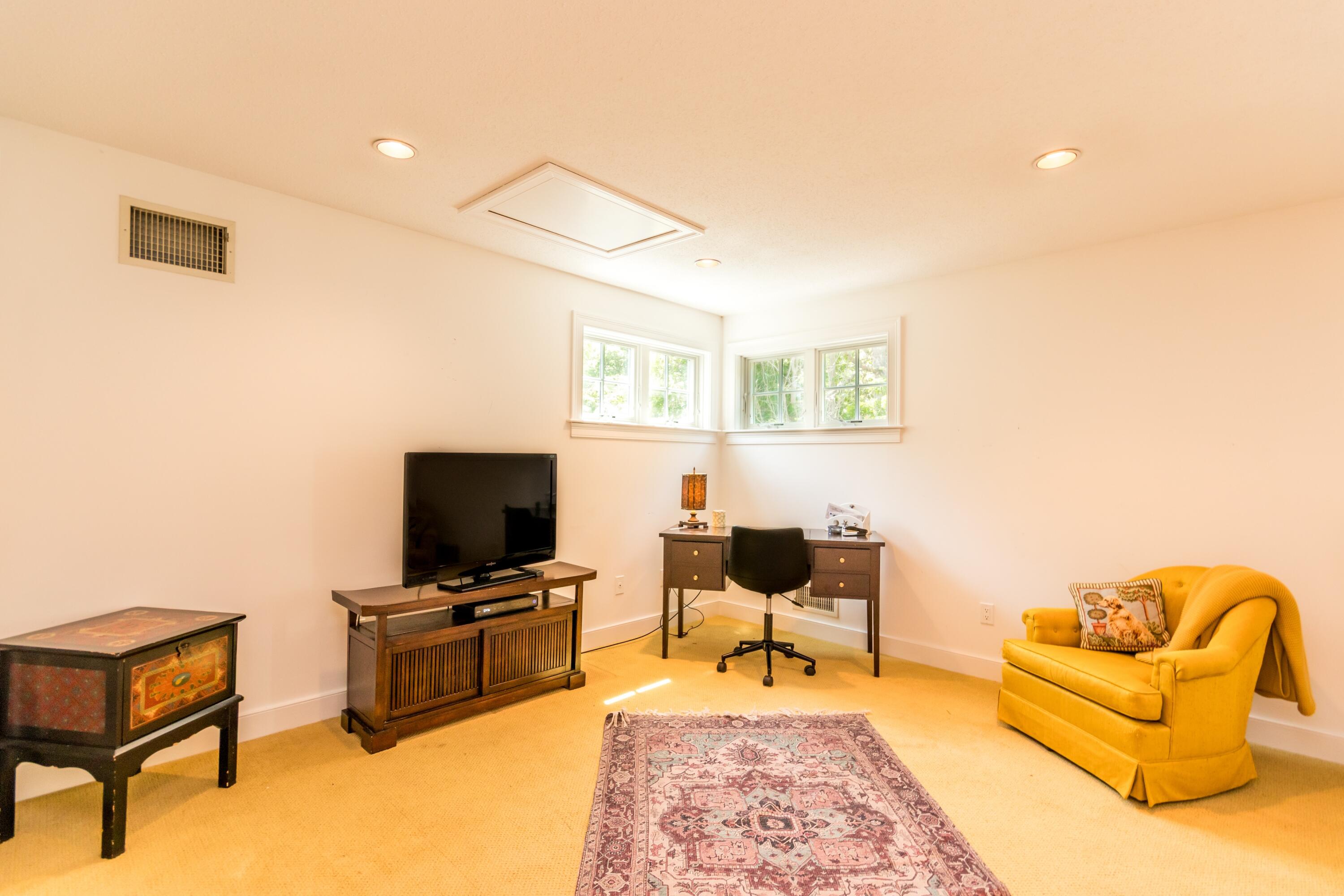 15 Hampton Court, Unit 15 Mashpee, MA 02649 - Photo 28 of 40 a living room with furniture and a flat screen tv