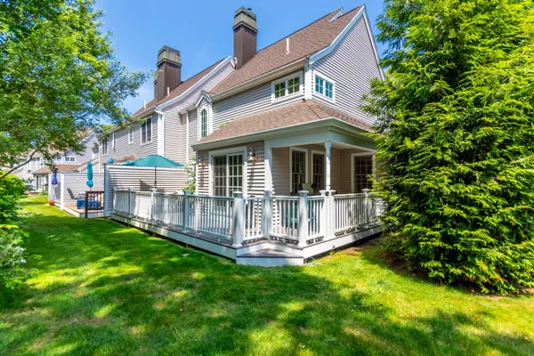 a front view of a house with a garden and yard