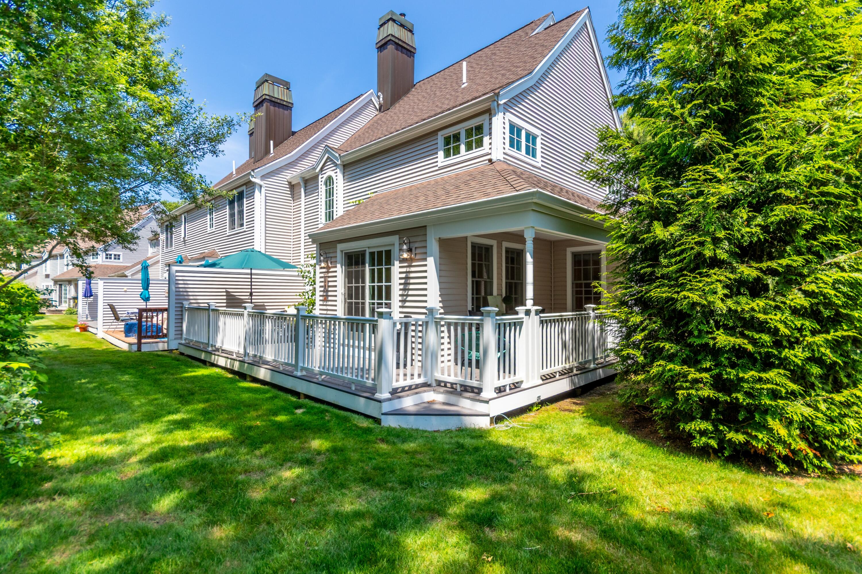 15 Hampton Court, Unit 15 Mashpee, MA 02649 - Photo 3 of 40 a front view of a house with a garden and yard
