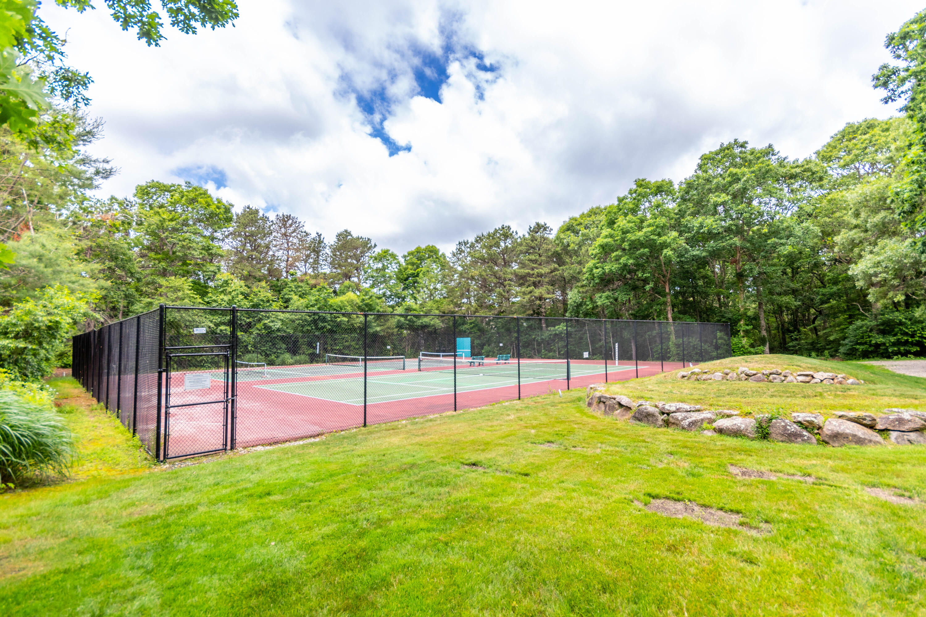 15 Hampton Court, Unit 15 Mashpee, MA 02649 - Photo 38 of 40 a view of a backyard with swimming pool