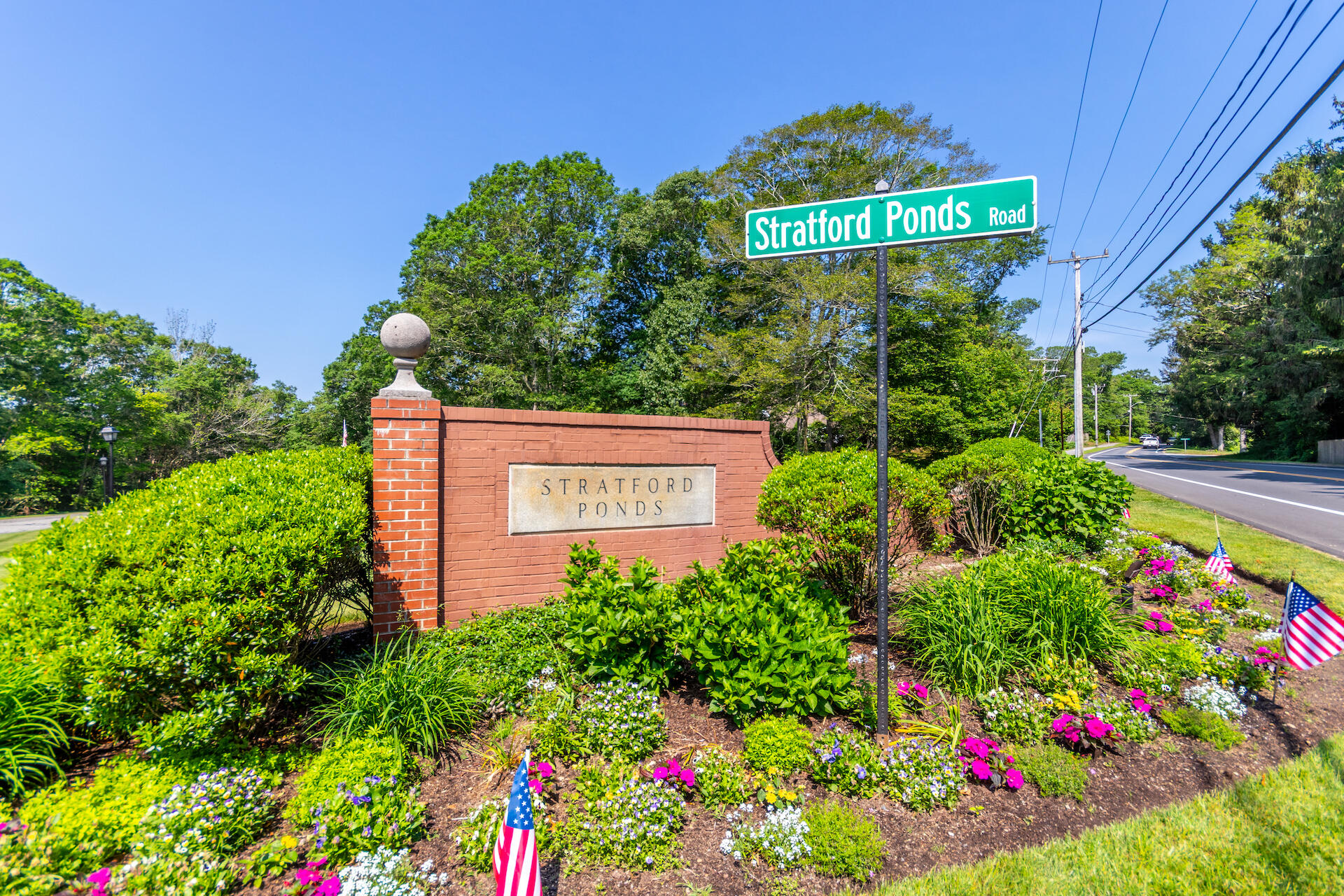 15 Hampton Court, Unit 15 Mashpee, MA 02649 - Photo 4 of 40 a sign that is in front of flowers