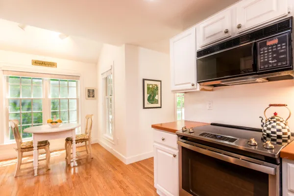 a living room with a stove and a flat screen tv