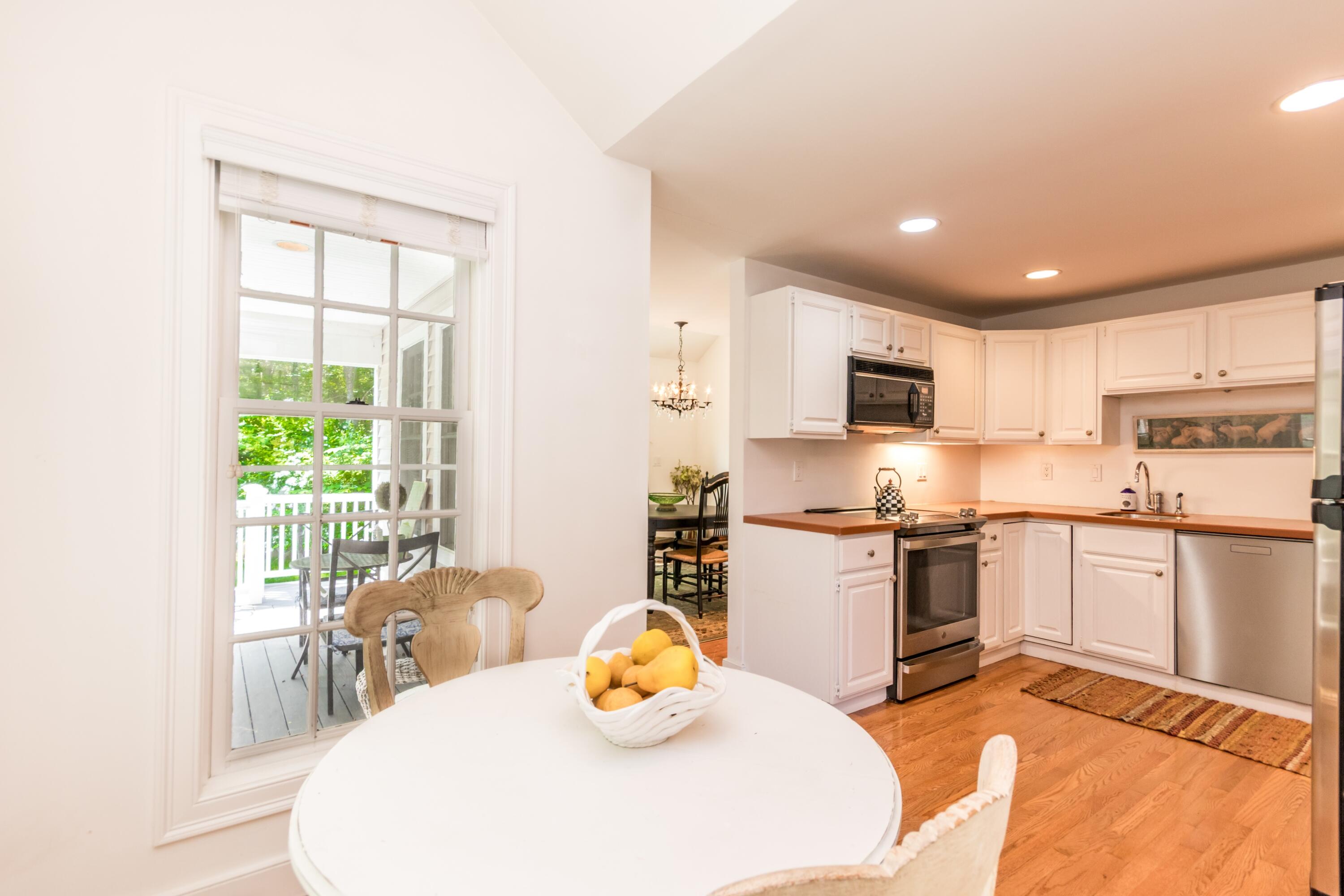 15 Hampton Court, Unit 15 Mashpee, MA 02649 - Photo 10 of 40 a kitchen with stainless steel appliances granite countertop a refrigerator a stove top oven a sink dishwasher and white cabinets with wooden floor