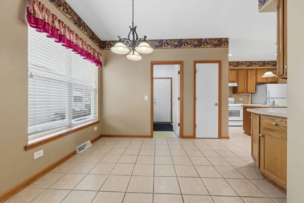 a kitchen with stainless steel appliances granite countertop a refrigerator a sink and a stove
