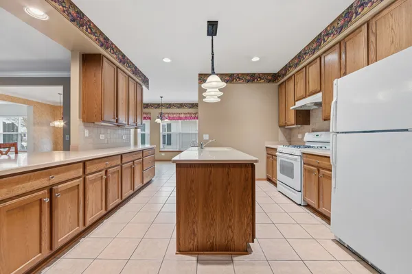 a kitchen with stainless steel appliances granite countertop a sink counter space cabinets and a large window