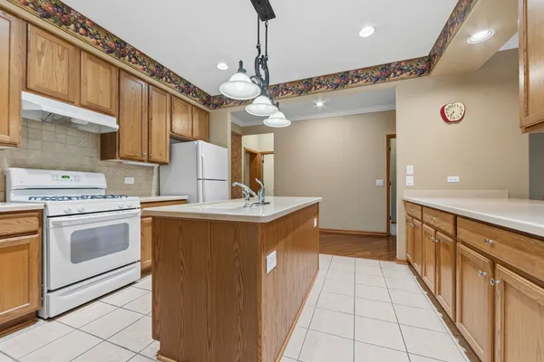a kitchen with a sink and a stove top oven