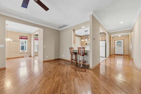a view of empty room with wooden floor