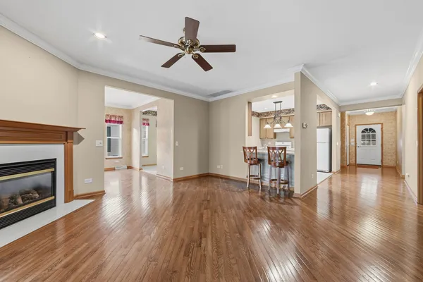 a living room with wooden floors and a fireplace