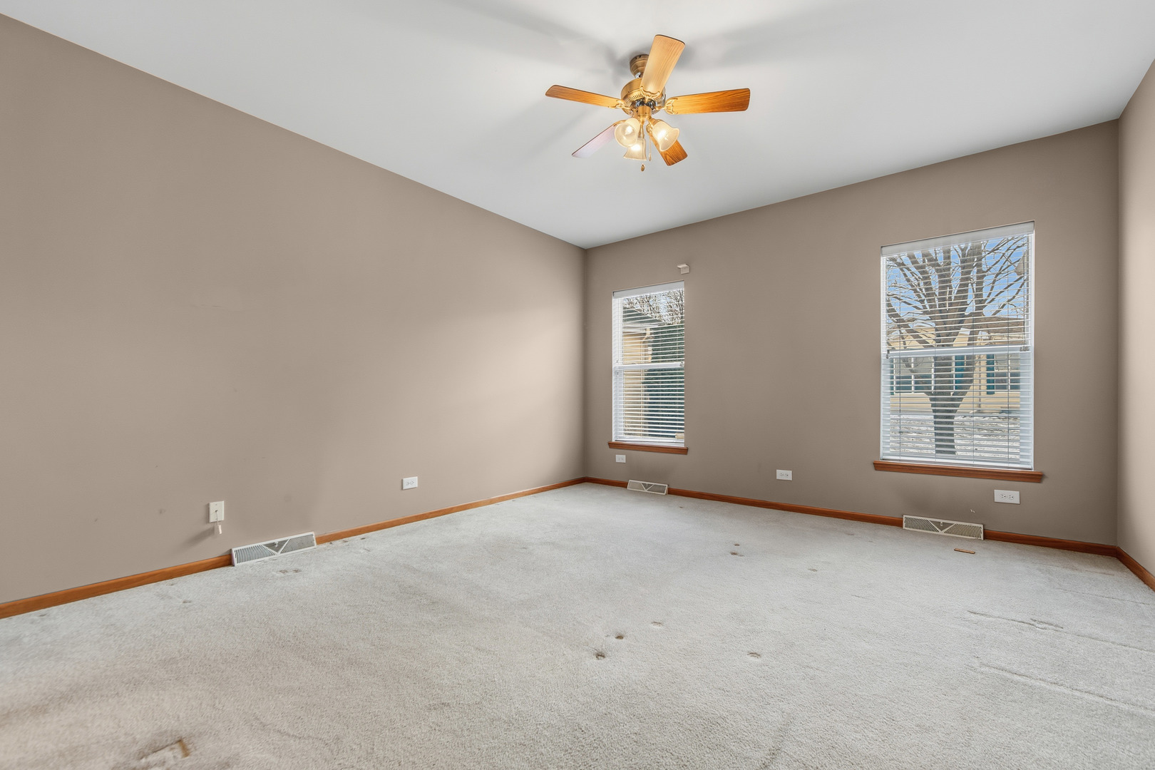 102 Hitching Post Lane Grayslake, IL 60030 - Photo 8 of 58 an empty room with windows and chandelier fan