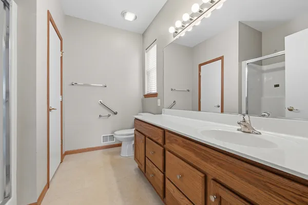 a spacious bathroom with a double vanity sink mirror and double
