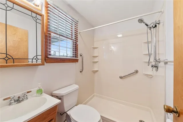 a bathroom with a sink toilet and shower