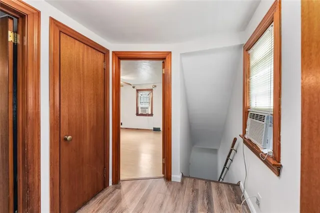 a view of an entryway with wooden floor