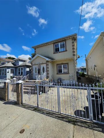 a view of a house with wooden fence