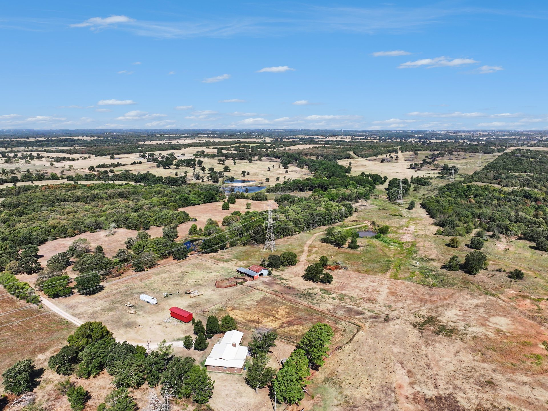 12526 3520th Road Seminole, OK 74868 - Photo 39 of 42 Expansive land featuring mature trees, a single-story residence, and an accessory structure