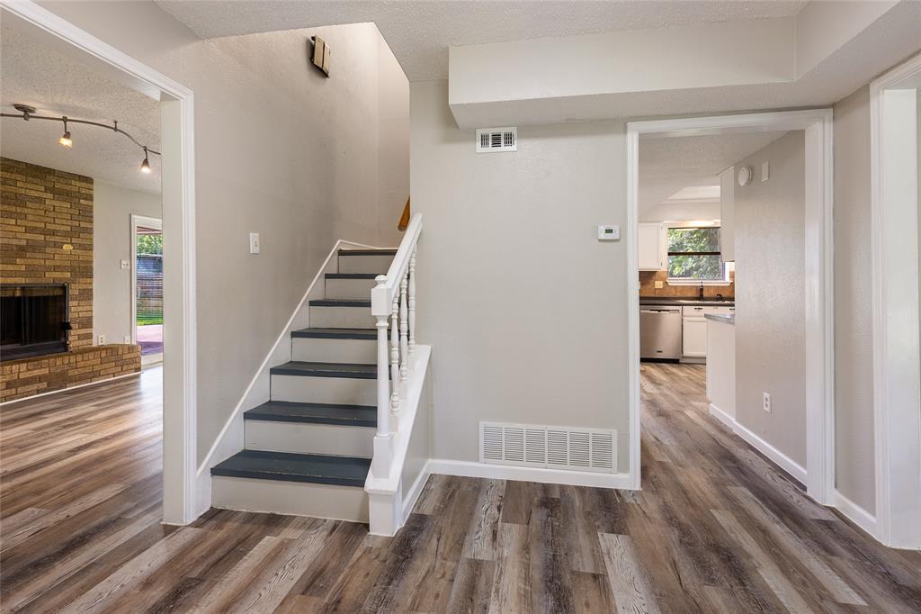2820 Bois D'Arc Street Commerce, TX 75428 - Photo 3 of 40 a view of a hallway view with wooden floor and staircase