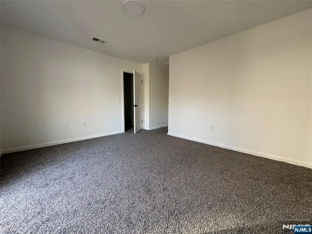 a view of an empty room and entryway