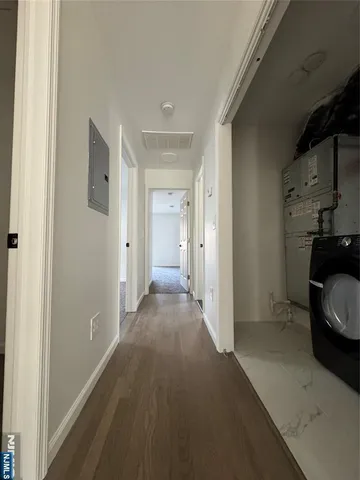 a view of a livingroom with wooden floor and a sink