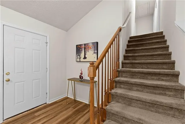 a view of entryway and hall with wooden floor