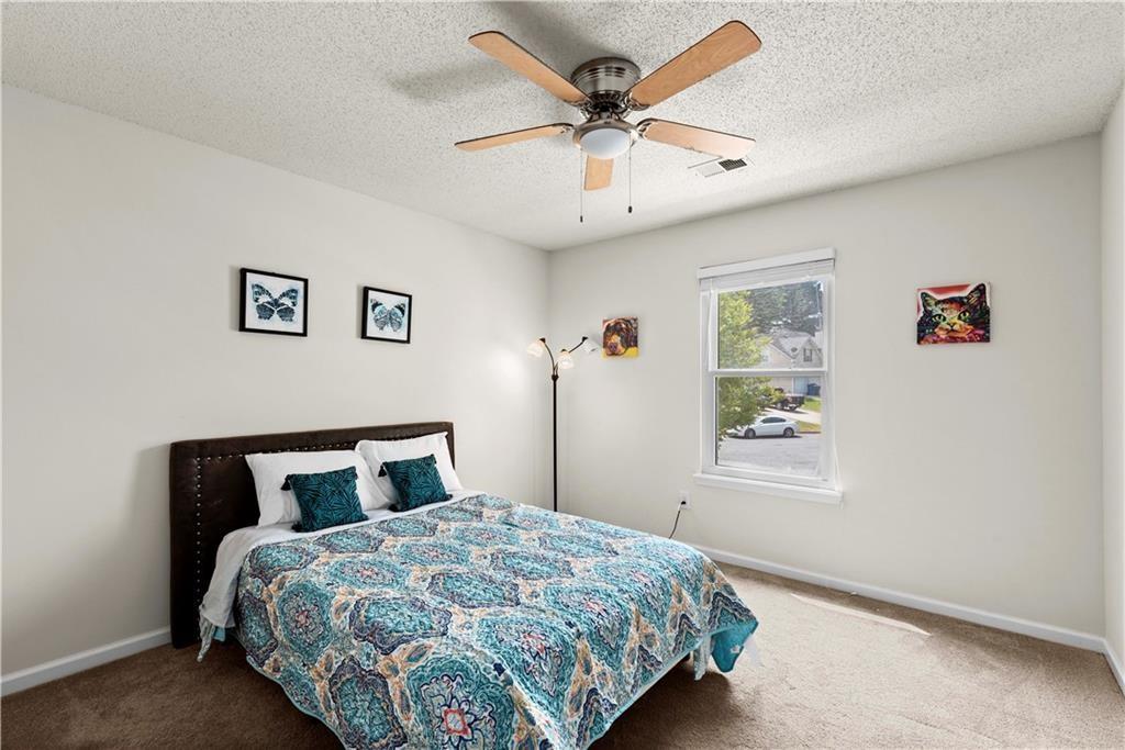 1700 English Ivey Lane Kennesaw, GA 30144 - Photo 19 of 29 a bedroom with a large bed and a window