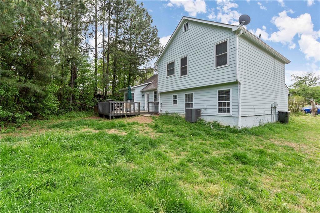 1700 English Ivey Lane Kennesaw, GA 30144 - Photo 2 of 29 a view of a house with backyard and garden