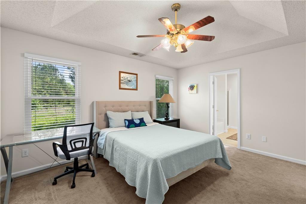 1700 English Ivey Lane Kennesaw, GA 30144 - Photo 22 of 29 a bedroom with a bed and a chandelier