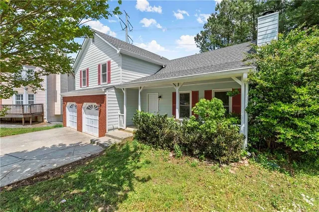 a front view of a house with garden