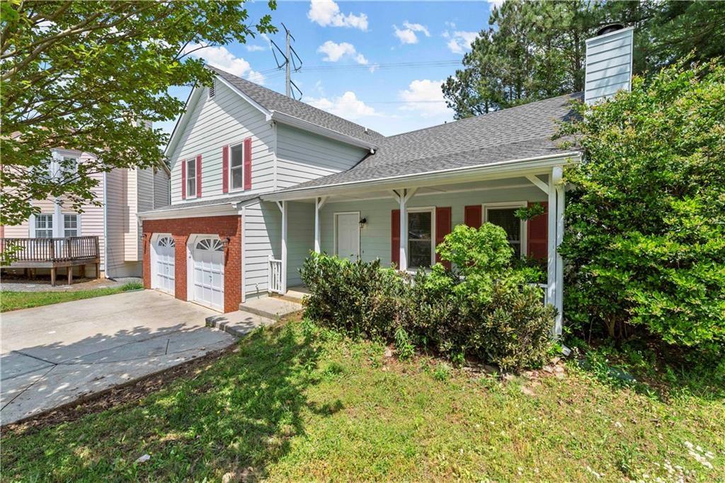 1700 English Ivey Lane Kennesaw, GA 30144 - Photo 3 of 29 a front view of a house with garden