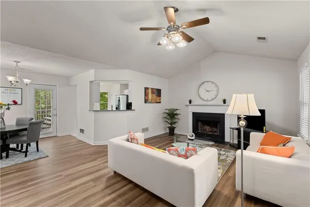 a living room with furniture a fireplace and a table