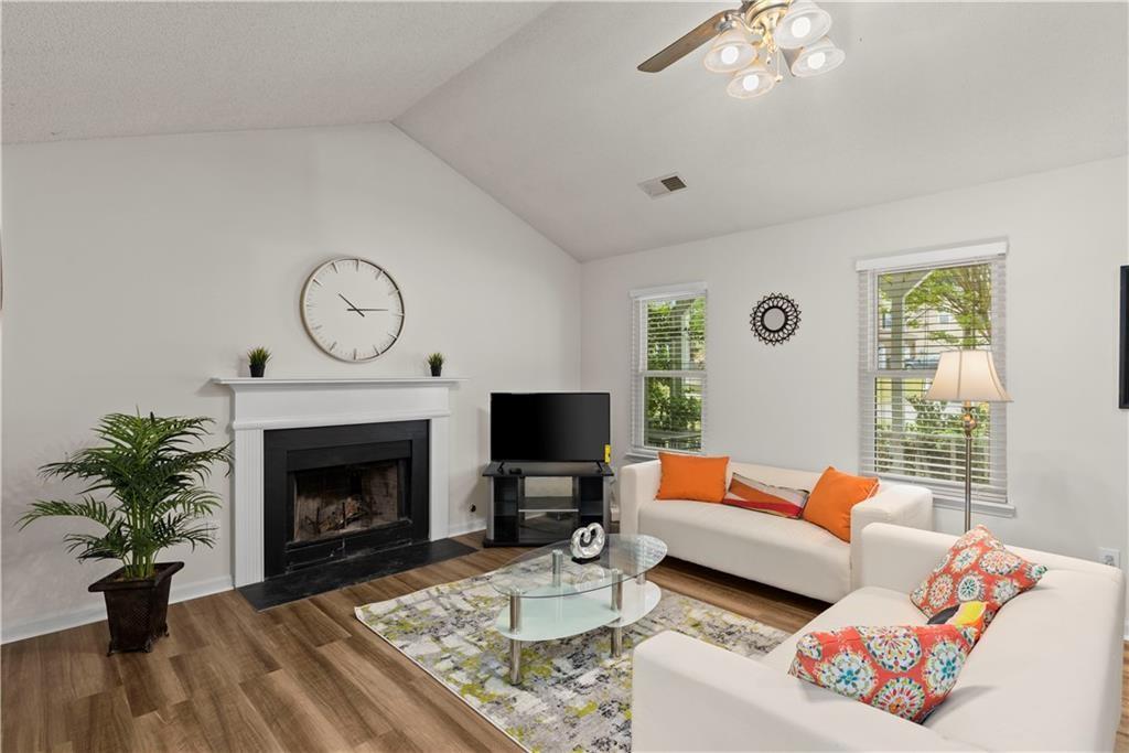 1700 English Ivey Lane Kennesaw, GA 30144 - Photo 7 of 29 a living room with furniture a fireplace and a window