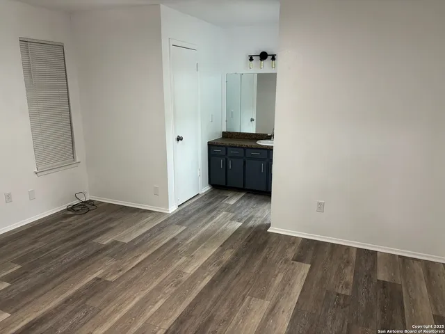 a room with wooden floor and window