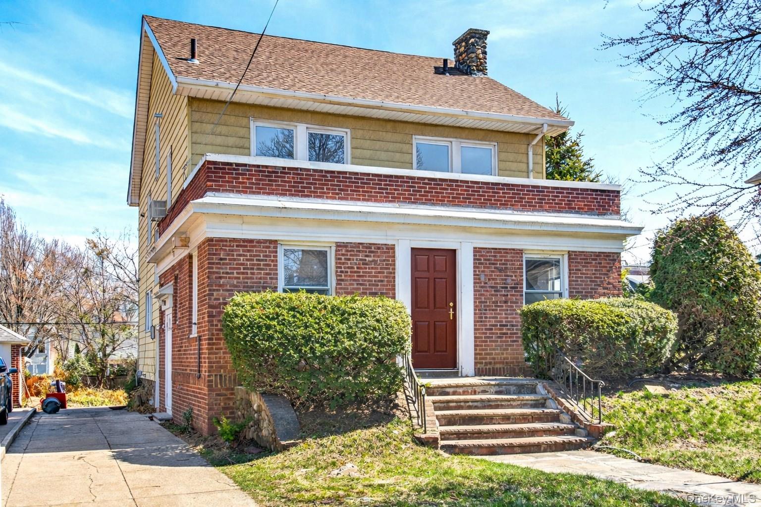 35-71 162nd Street Queens, NY 11358 - Photo 3 of 11 a front view of a house with garden