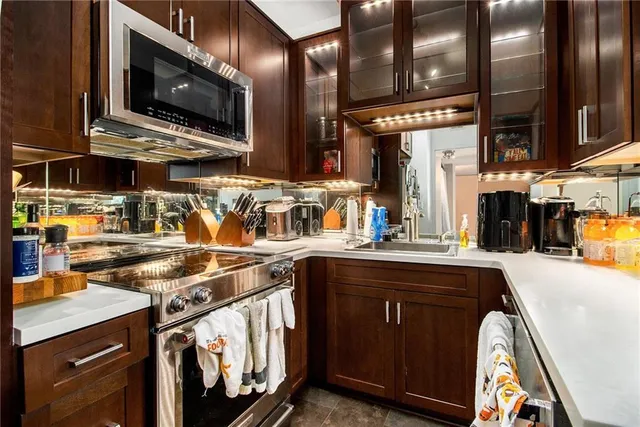 a kitchen with stainless steel appliances granite countertop a sink and a stove