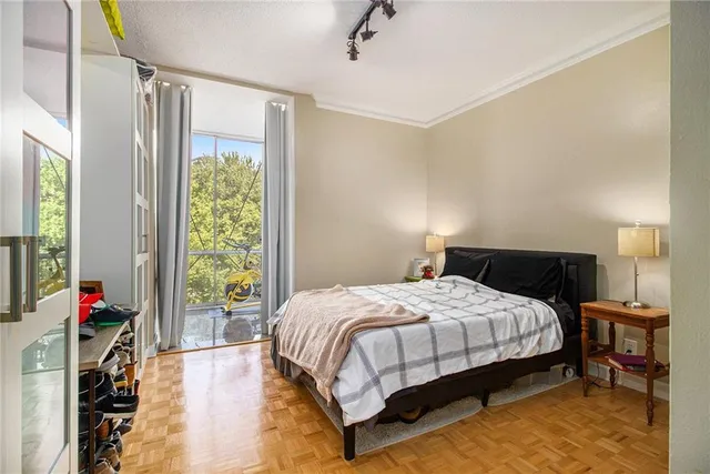 a bedroom with a bed and a large window