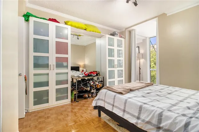 a bedroom with a bed and a window