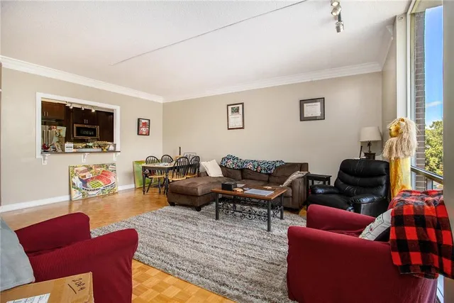 a living room with furniture a flat screen tv and a window