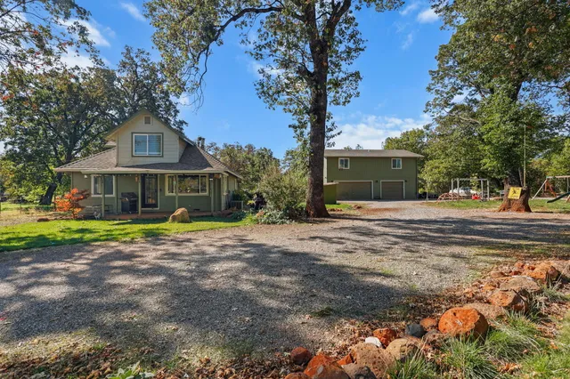 a front view of a house with swimming pool having outdoor seating