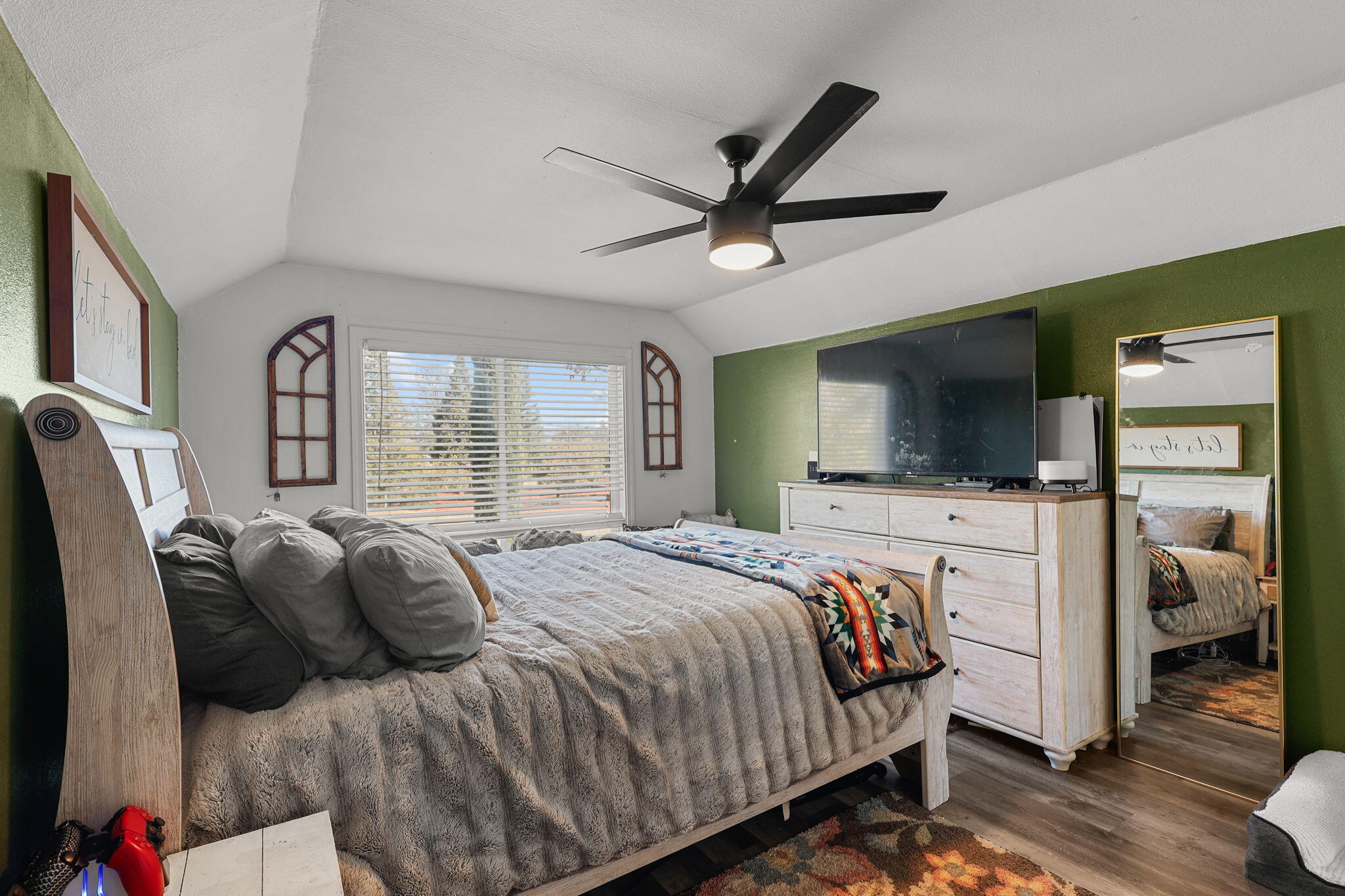 28093 Highway 44 Shingletown, CA 96088 - Photo 11 of 42 a bedroom with a large bed and a flat tv screen