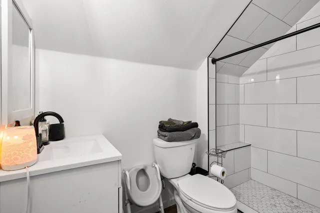 a white toilet sitting next to a bathroom sink