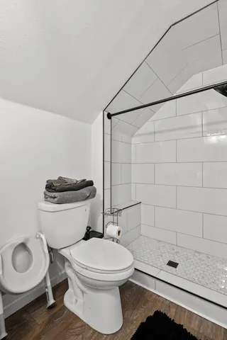 a bathroom with a toilet and a shower