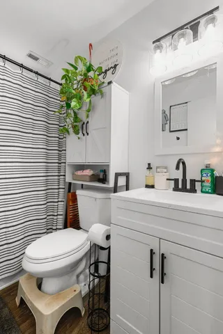 a bathroom with a sink toilet and mirror