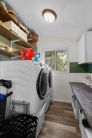 a storage room with wooden floor washer and dryer